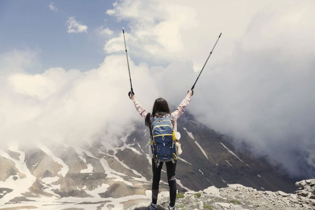 Traveler hiking in the mountains illustrating the importance of travel insurance for adventure activities