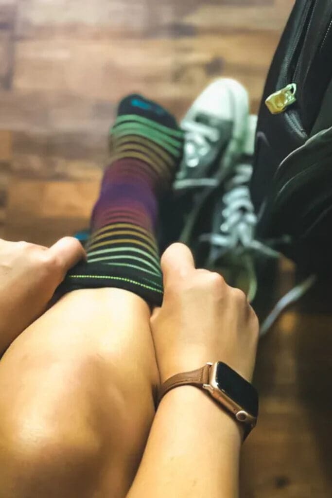 Traveler putting on compression socks before a long-haul flight