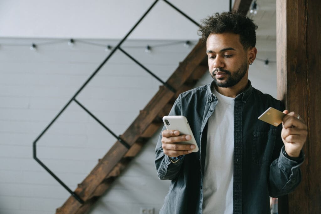 Traveler comparing credit card benefits and travel insurance options before a trip
