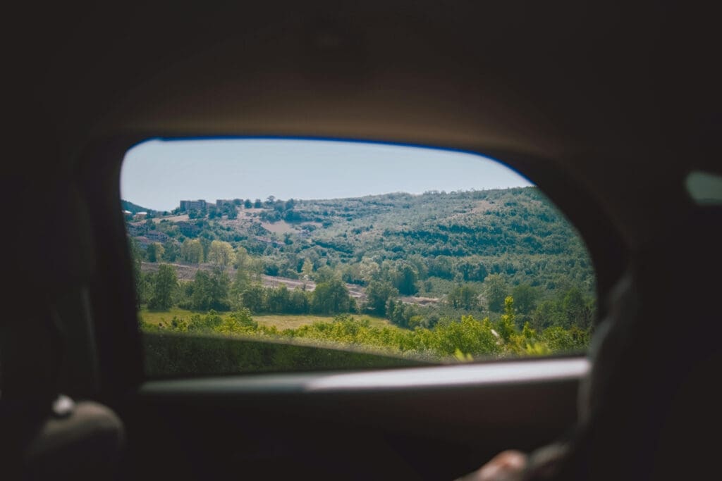 Countryside seen through a car window while driving abroad