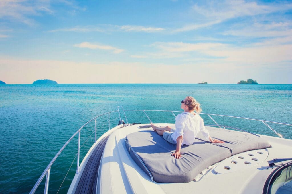 Traveler enjoying a luxury boat experience highlighting the value of comprehensive travel insurance