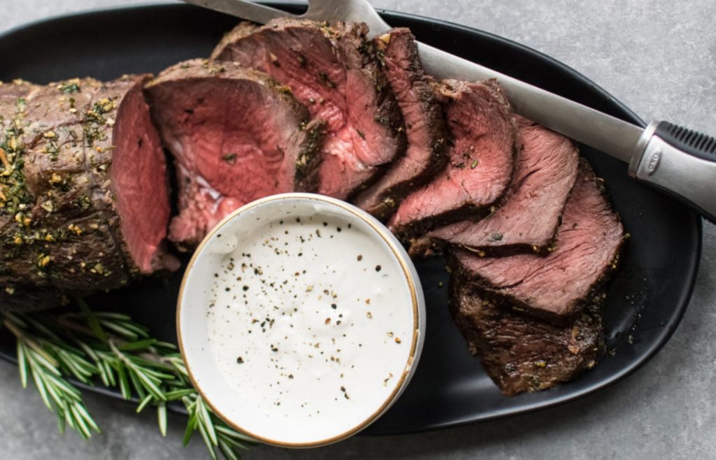 Sliced roast beef served with horseradish sauce
